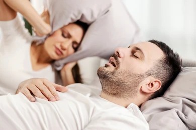 man-snoring-sleeping-bed-while-260nw-2102981113 Snoring man disrupts his wife's sleep due to loud snoring and obstructive sleep apnea.
