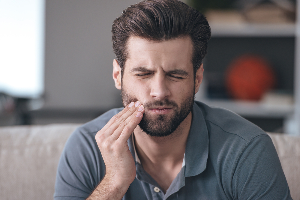 A woman in pain due to a toothache. Man with facial injury has a wonky bite.